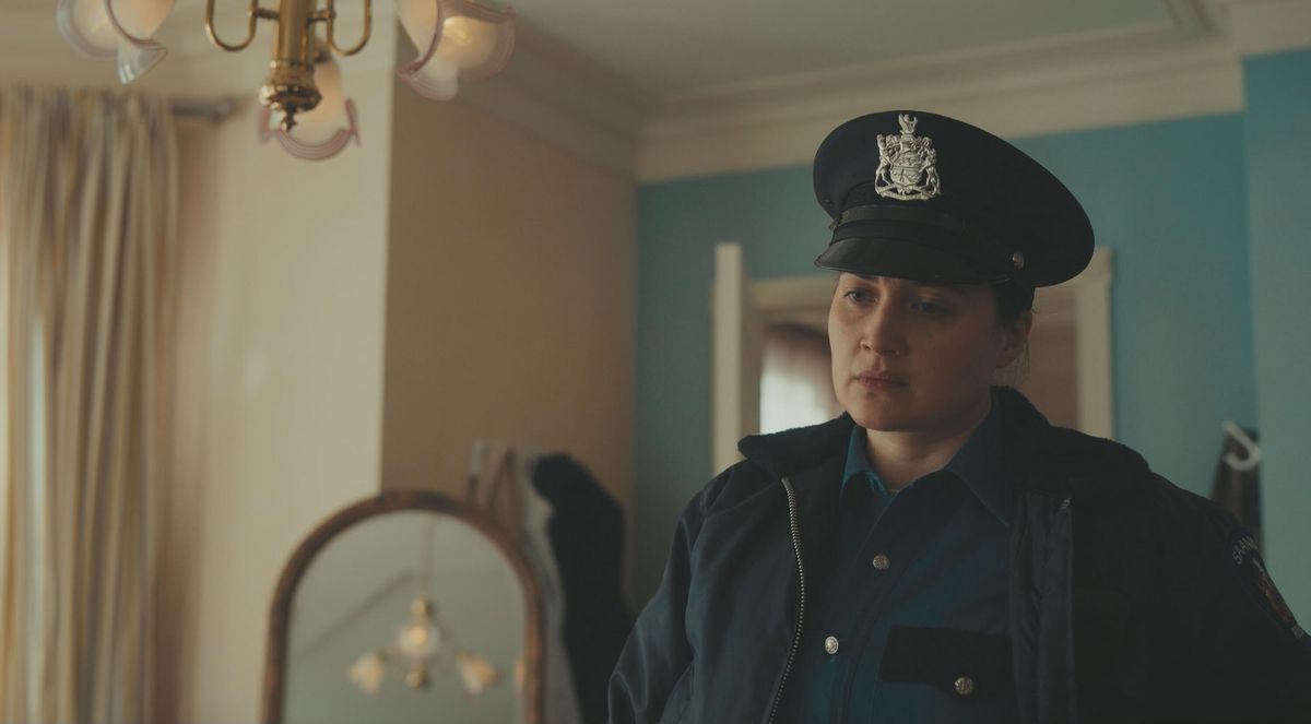 Lily Gladstone, wearing a police officer’s uniform, in Under the Bridge