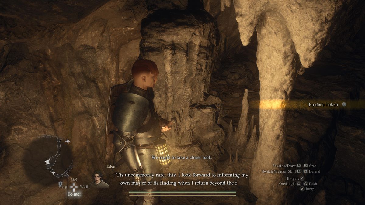 A person picks up a Finder’s Token in a cave for the Riddle of Rumination during the “A Game of Wits” side quest for Sphinx riddles in Dragon’s Dogma 2.
