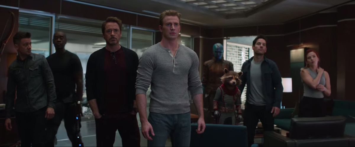 Iron Man, Captain America, Hawkeye, Black Widow, Nebula, Rocket Raccoon, Ant-Man, and War Machine stand in a line in Avengers: Endgame