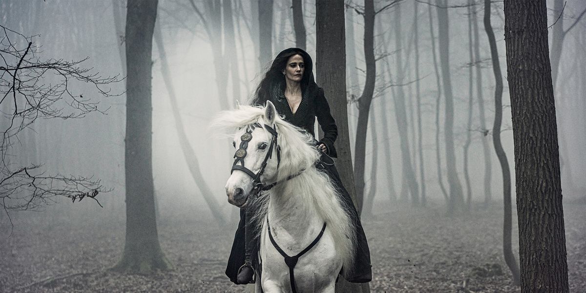 Eva Green rides a white horse in a foggy forest in The Three Musketeers - Part II: Milady