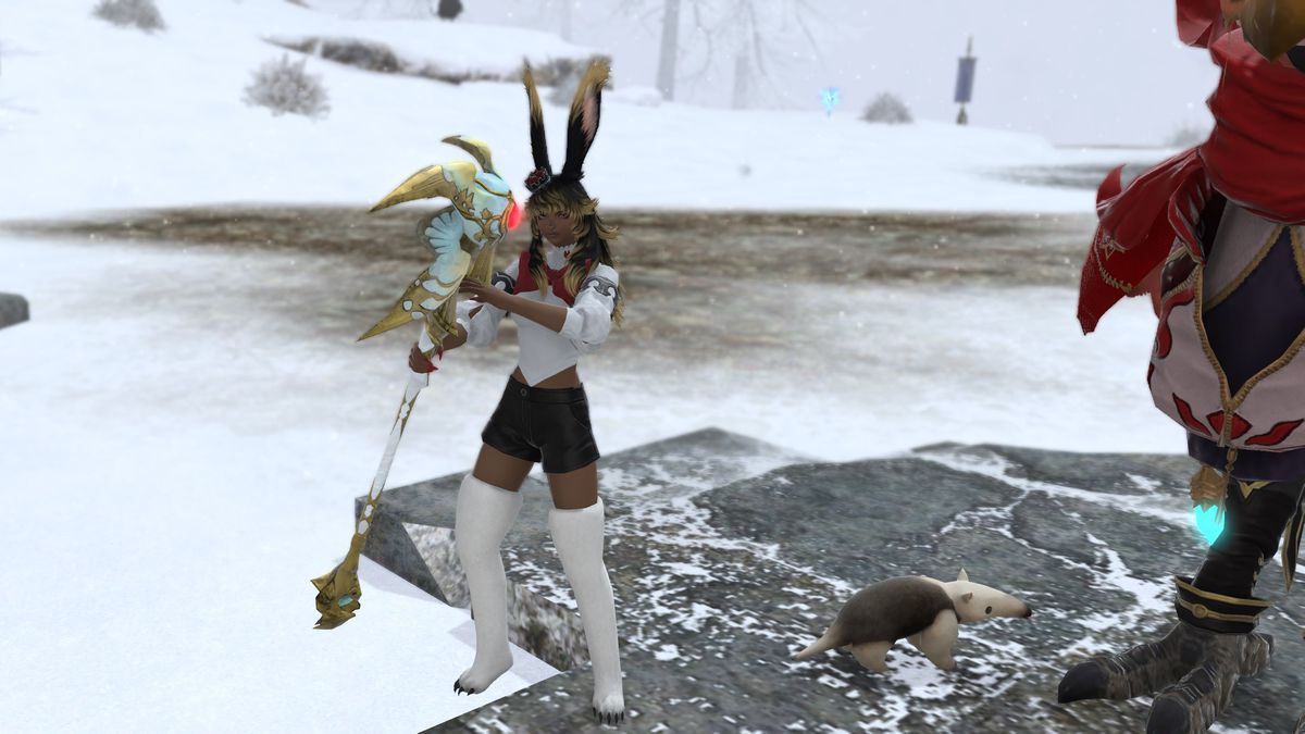 A FFXIV Viera stands in the snow with a staff with a blue and gold head with a giant red gem glowing in the center.