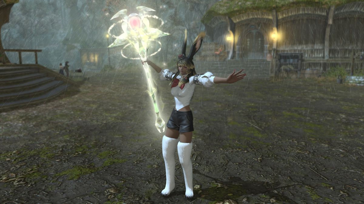 A FFXIV Viera holds up a glowing staff with rings around the head