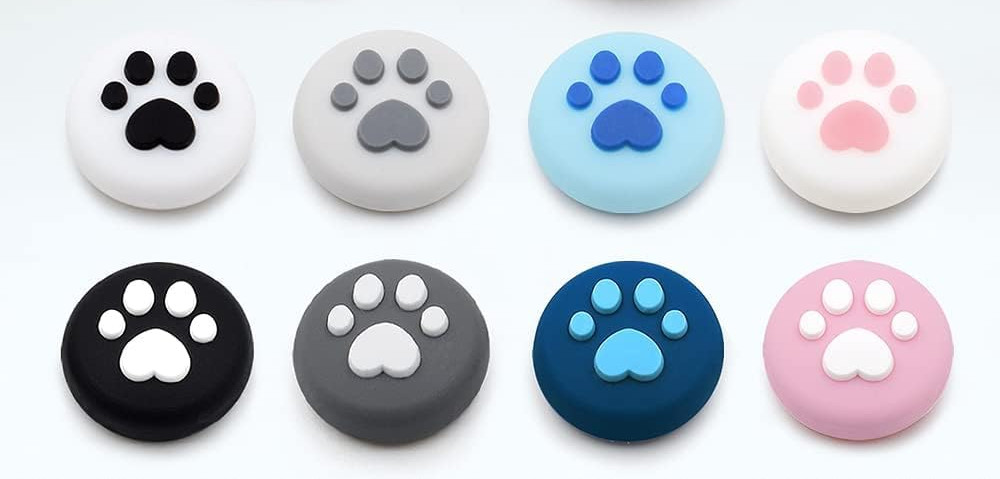 A stock photo of eight silicon thumbstick covers shaped like cats post