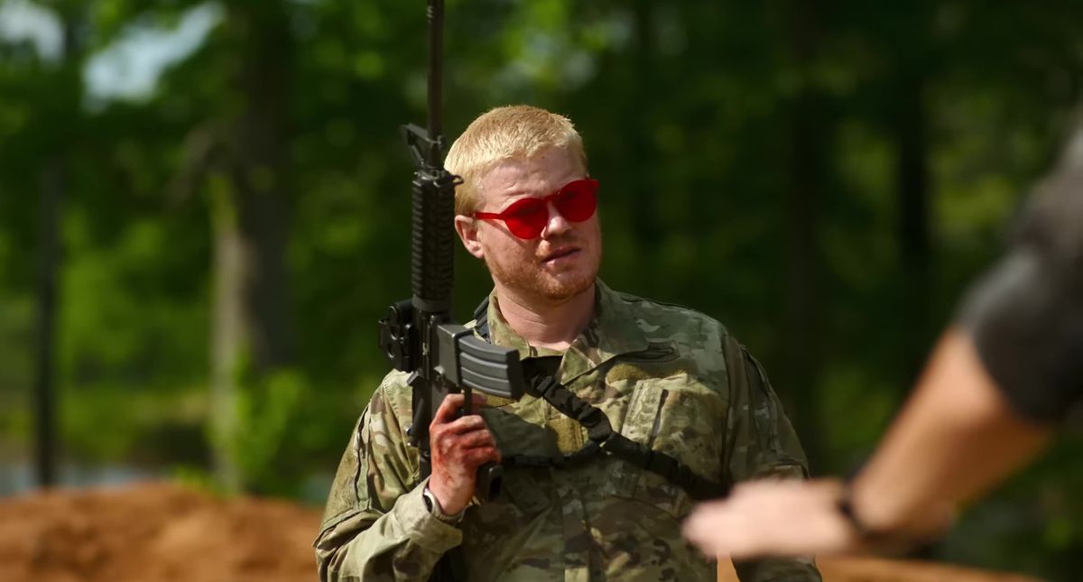 Jesse Plemons, klädd i militära utmattningar och röda solglasögon och med ett gevär, i inbördeskriget
