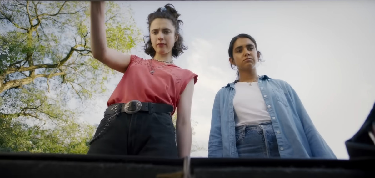 Margaret Qualley and Geraldine Viswanathan looking into a trunk in Drive-Away Dolls