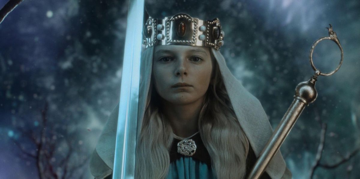 A young blonde boy holds a shining sword while wearing a crown in The Northman