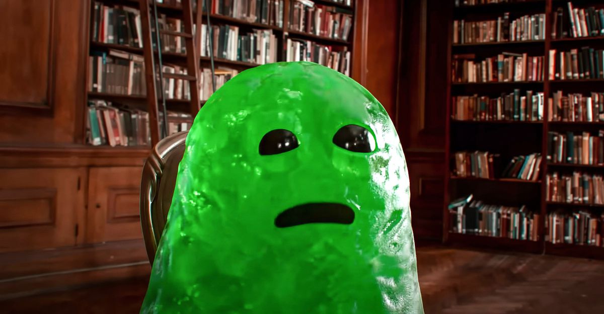 Slime, en CG-fantastisk vän som ser ut som en stor, grön kula med glänsande svarta ögon och en svart urtagning för en mun, sitter i ett bibliotek i John Krasinskis IF