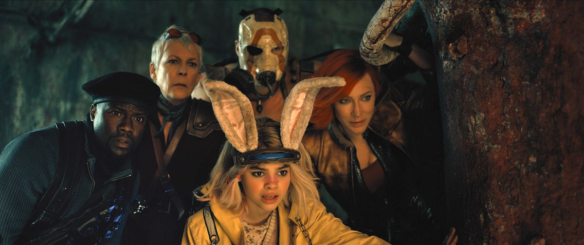 Kevin Hart as Roland, Jamie Lee Curtis as Tannis, Ariana Greenblatt as Tiny Tina, Florian Munteanu as Krieg, and Cate Blanchett as Lilith in Borderlands. They are all dressed outlandishly, peering around a rusted metal structure looking apprehensive. 