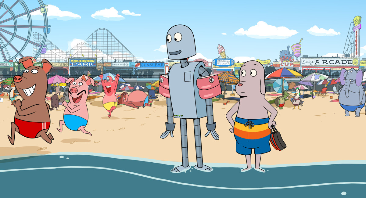 Dog and Robot at the beach — amusement park rides and boardwalk restaurants are visible behind them. They watch as three pigs in bathing suits dash towards the water in Robot Dreams. 