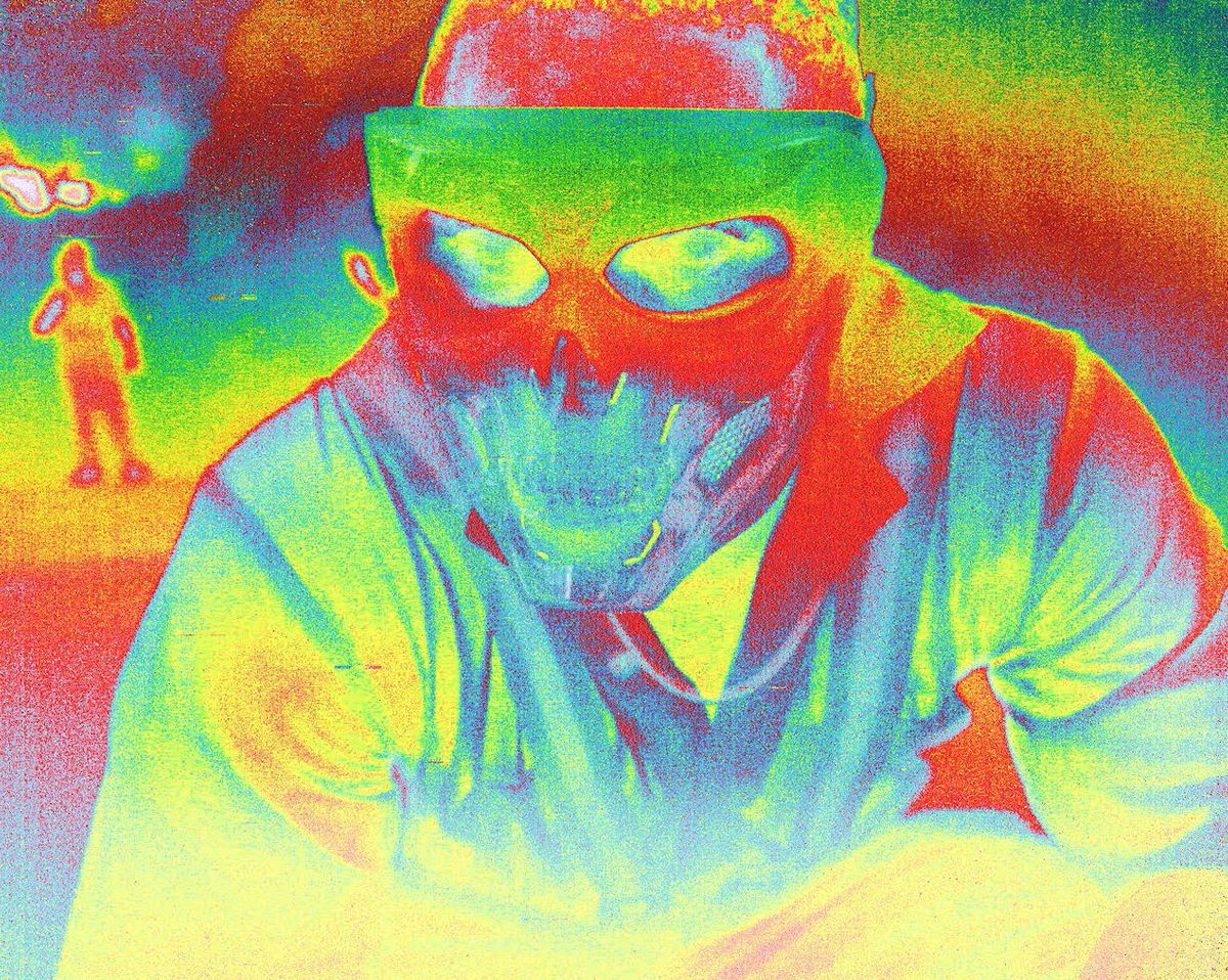An infrared close-up of a man wearing a mask with protruding skull teeth in AGGRO DR1FT.