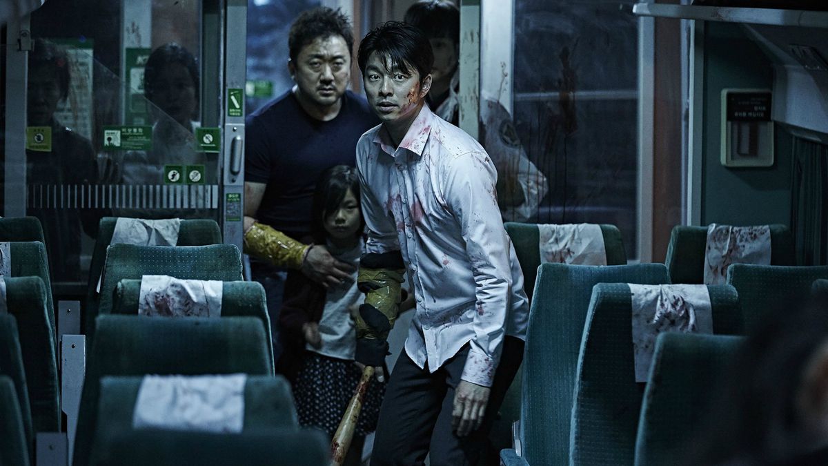 A disheveled man and a larger man holding a child stand at the far end of train car holding weapons in Train to Busan.