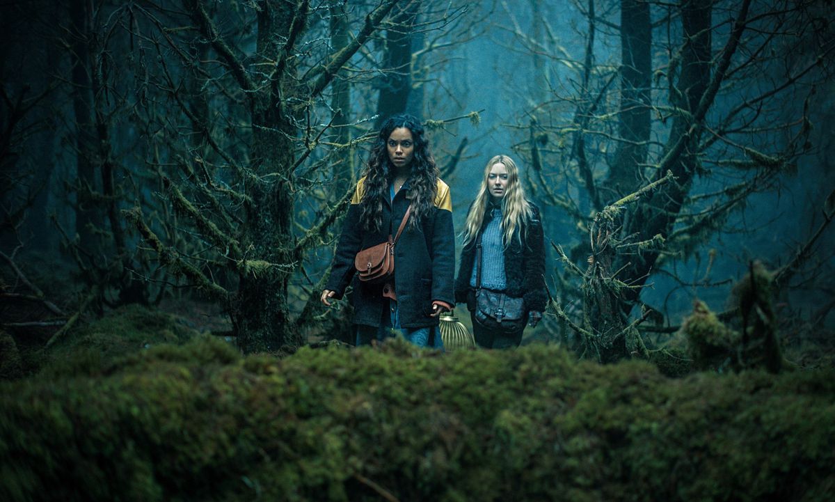 Mina (Dakota Fanning) och Ciara (Georgina Campbell) går genom en mörk skog i Ishana Night Shyamalans The Watchers